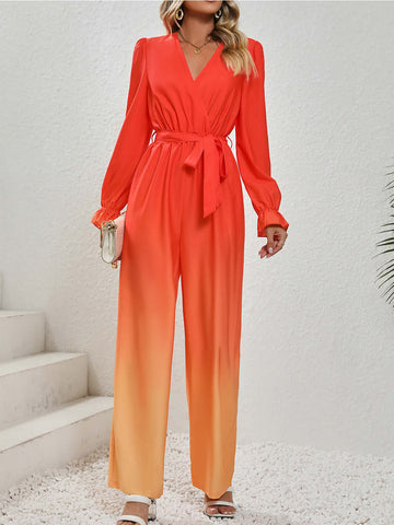 Stylish woman wearing a vibrant orange gradient jumpsuit with long sleeves and a tied waist, perfect for any occasion.