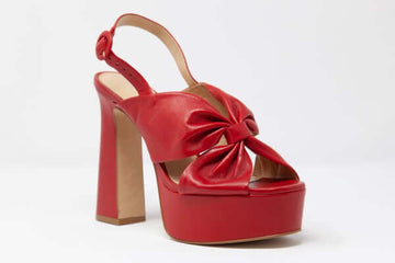 Stylish red platform heels with a bow for women, perfect for fashion-forward outfits and trendy occasions.
