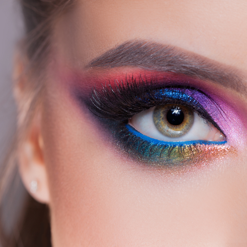 Close-up of a vibrant eye makeup look showcasing colorful eyeshadow and bold mascara, highlighting eye makeup products.