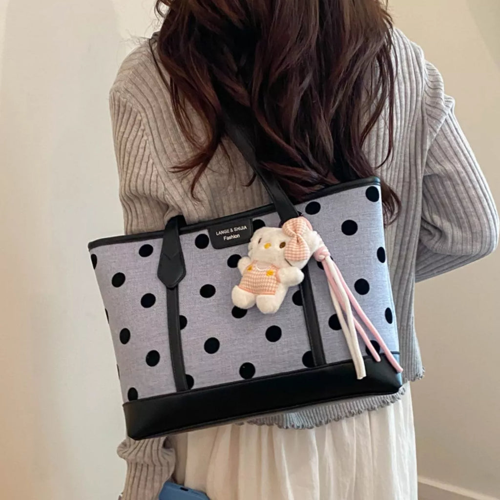 Medium polka dot shoulder bag featuring a cute teddy charm and classic black and white design.