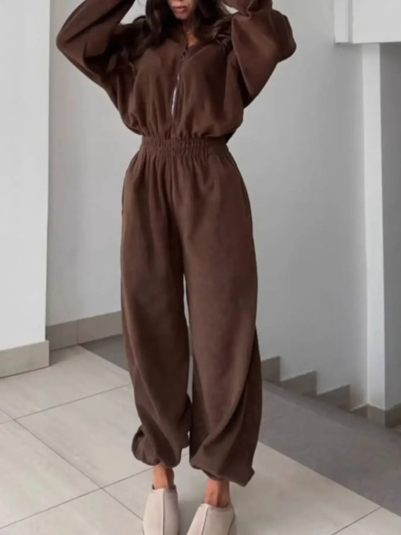 Women's jumpsuit zip front long sleeve in brown, featuring a relaxed fit and stylish long sleeves.