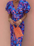 Model wearing a vibrant plus size puff sleeve midi dress with an orange bag, showcasing style and elegance.