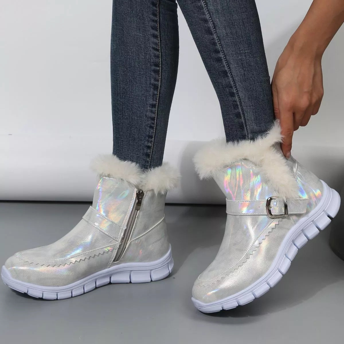 Ankle boots with fur lining in shiny silver with faux fur detail, perfect for stylish winter looks.