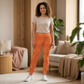 Model wearing Leo constellation leggings in sunset-orange with golden sunbursts, showcasing bold summer energy.