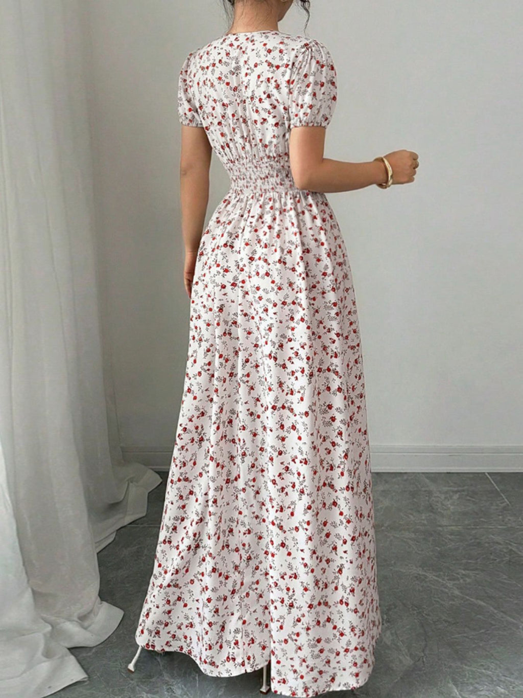 Back view of a woman wearing a Floral Print V-Neck Maxi Dress with short sleeves and a flowing silhouette.