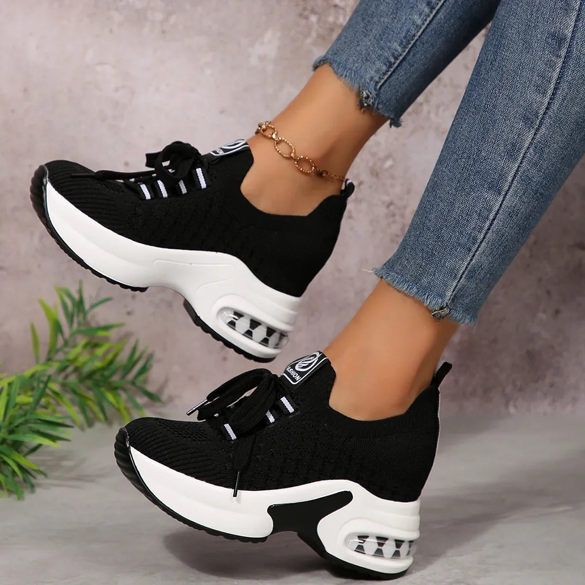 Lace Up Platform Sneakers with bold white sole and stylish black knit upper, perfect for casual and trendy outfits.
