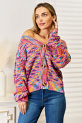 Long sleeve cardigan in colorful knit with buttons, styled casually, showcasing an off-shoulder look and vibrant design.