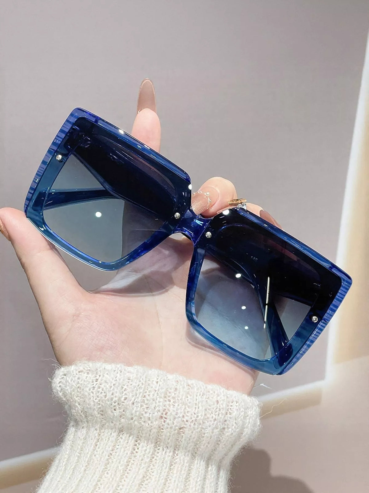 Oversized Square Sunglasses UV400 | Lightweight PC Frame, stylish blue sunglasses in hand, UV protection lenses.