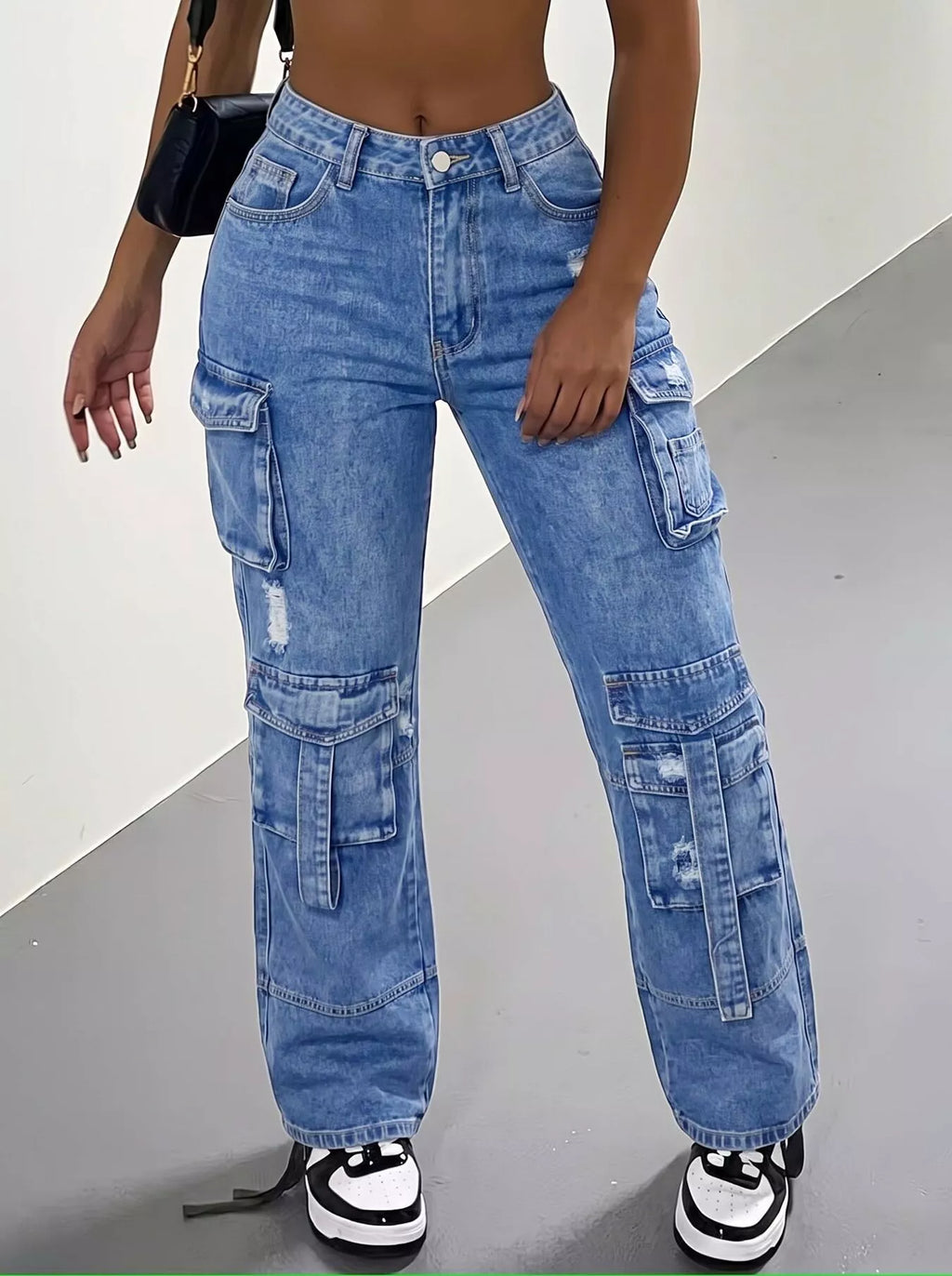 Trendy cargo jeans featuring a distressed high-waisted fit, perfect for a fashionable wardrobe.