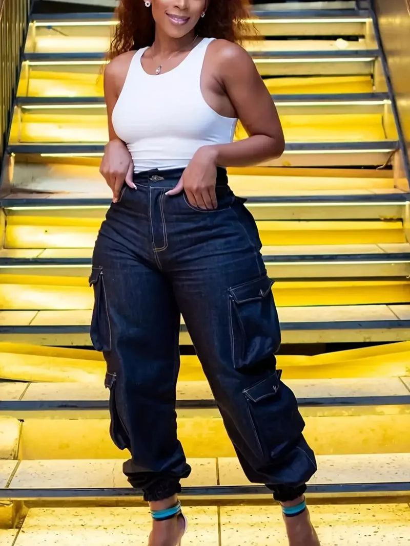 Fashionable plus size jeans - model wearing high-waisted cargo jeans standing on stairs.