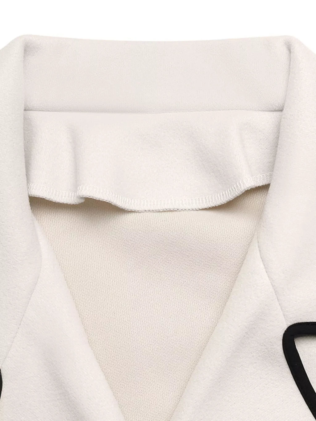 Contrast Trim Double-Breasted Jacket collar detail showcasing classic sophistication and playful flair.