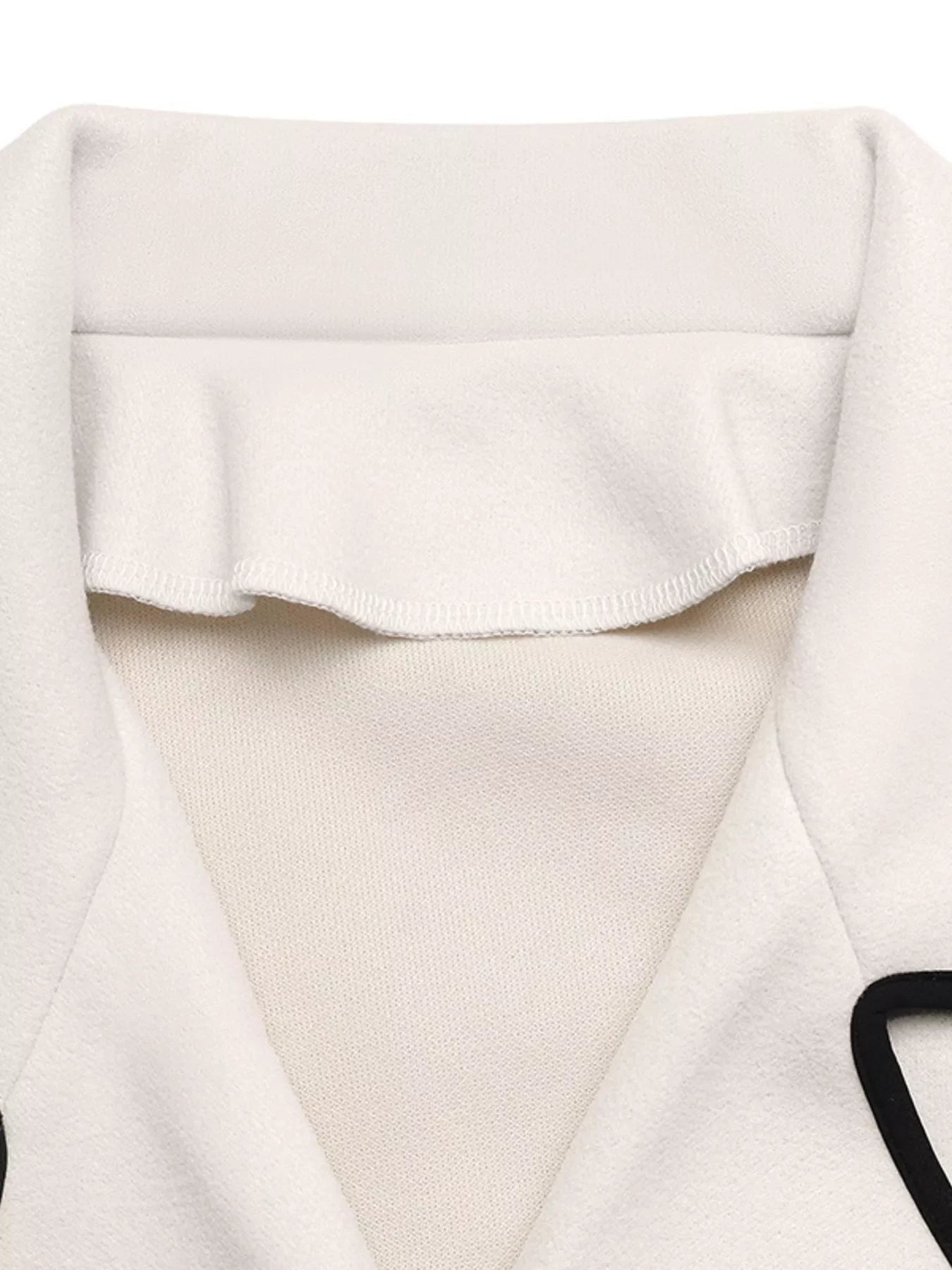 Contrast Trim Double-Breasted Jacket collar detail showcasing classic sophistication and playful flair.
