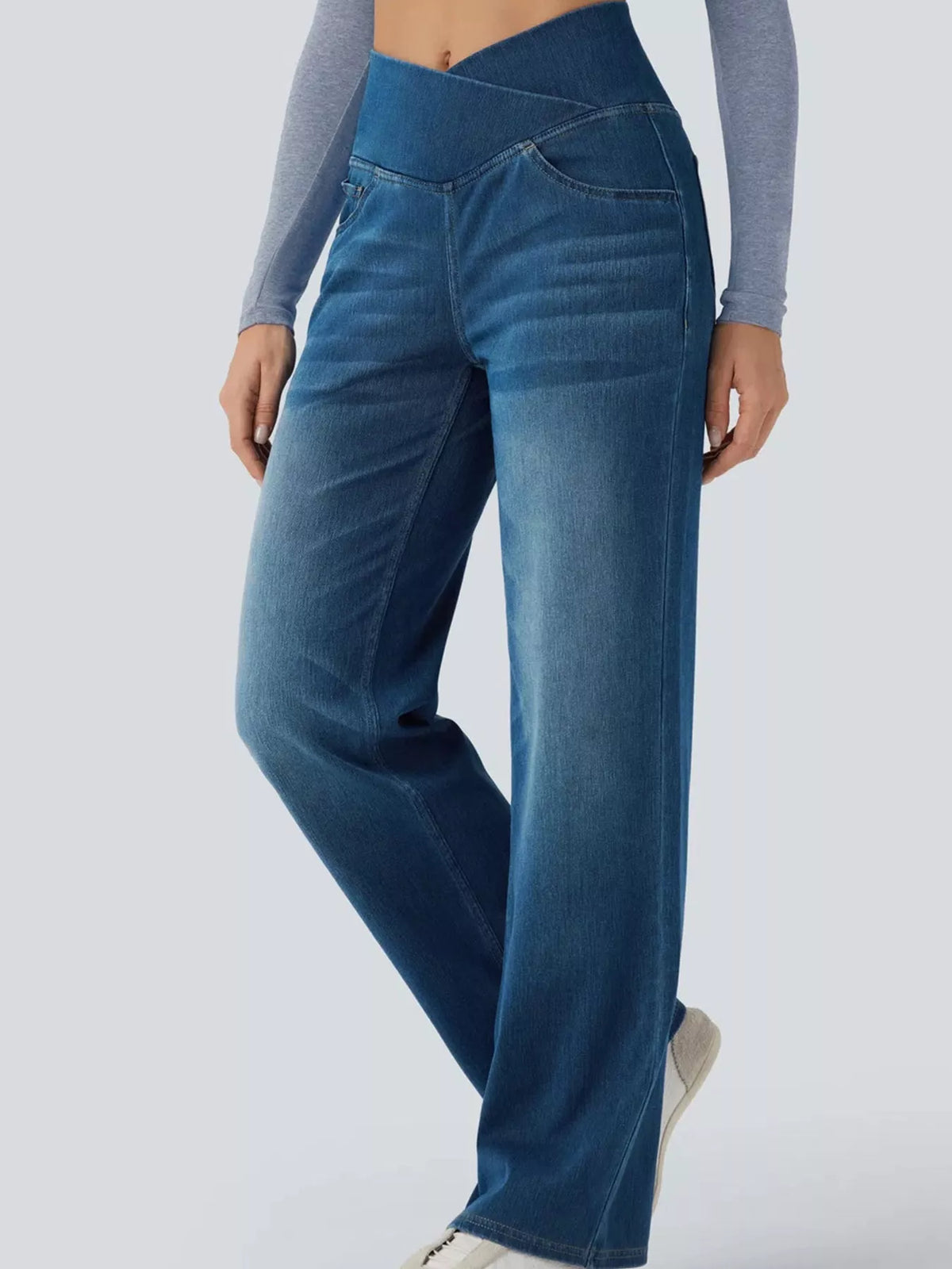 High-waisted crossover jeans featuring a stylish crisscross design and comfortable fit, perfect for everyday wear.