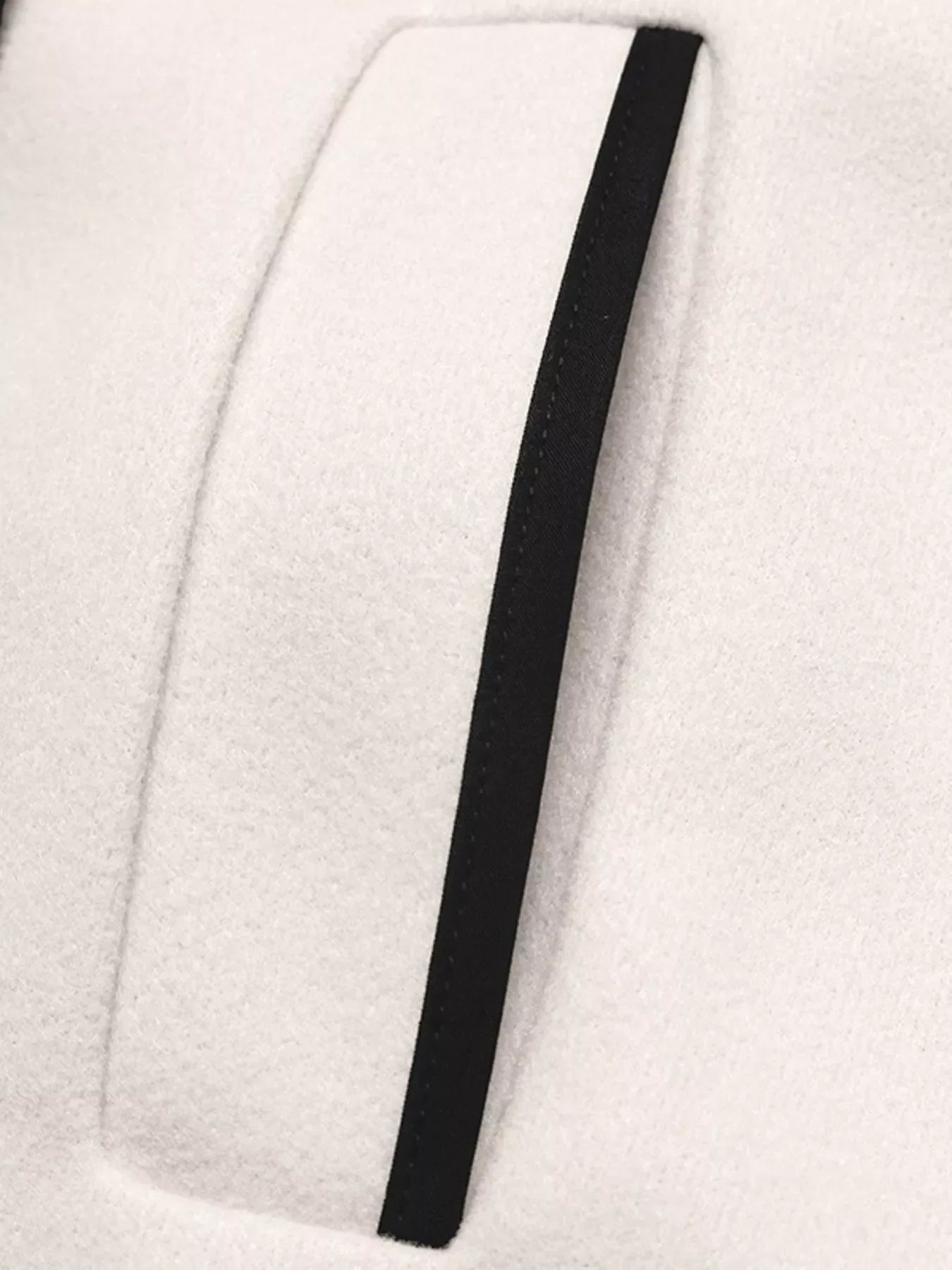 Close-up of the contrast trim on the Contrast Trim Double-Breasted Jacket, showcasing its stylish design.