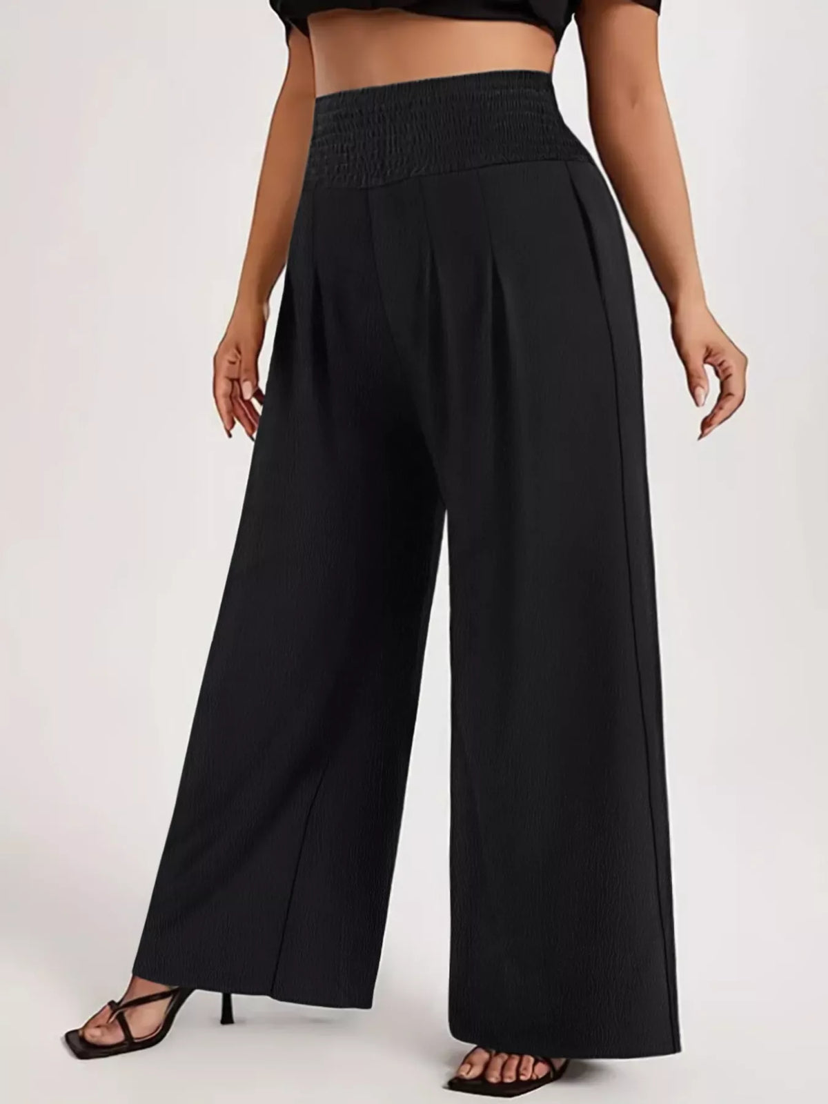 Plus Size High Waist Wide Leg Smocked Waist Pants in black, featuring a comfortable smocked waistband and stylish wide legs.