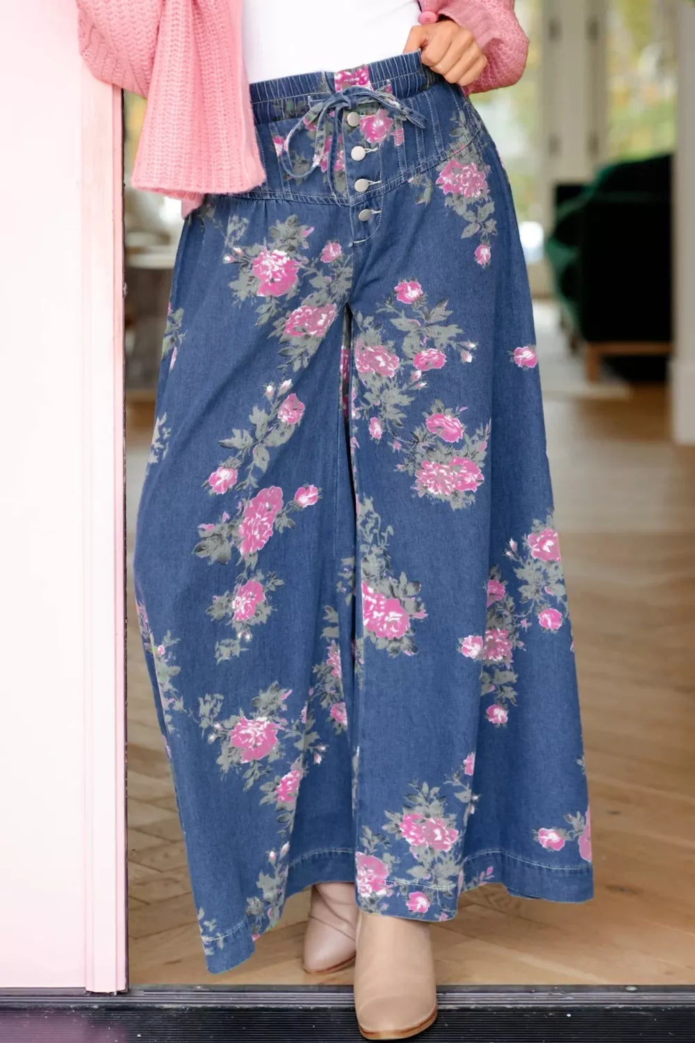 Stylish floral wide leg jeans featuring a drawstring waist and vibrant floral design, perfect for casual wear.