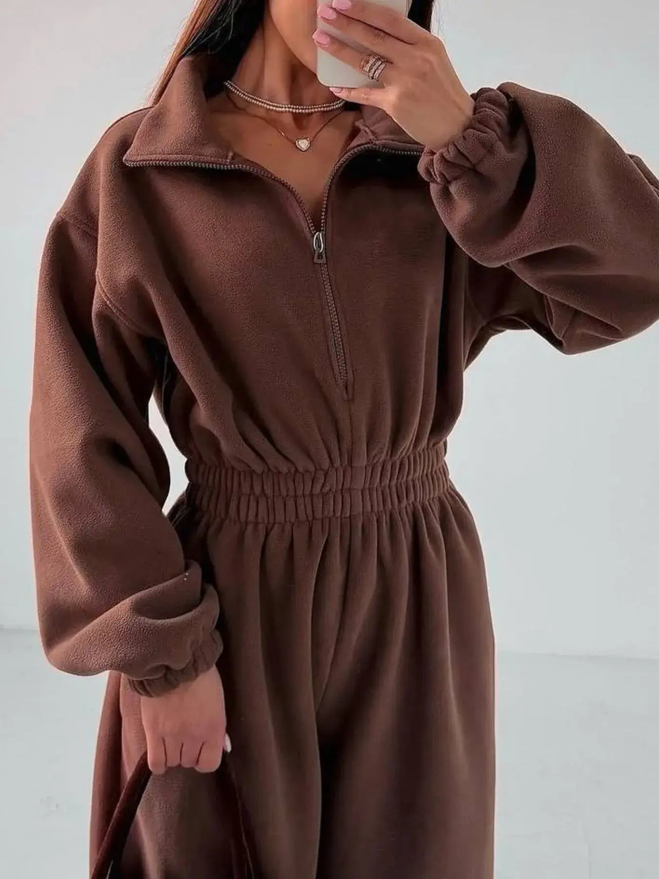 Women's jumpsuit with zip front and long sleeves in brown, featuring a comfortable fit and stylish design.