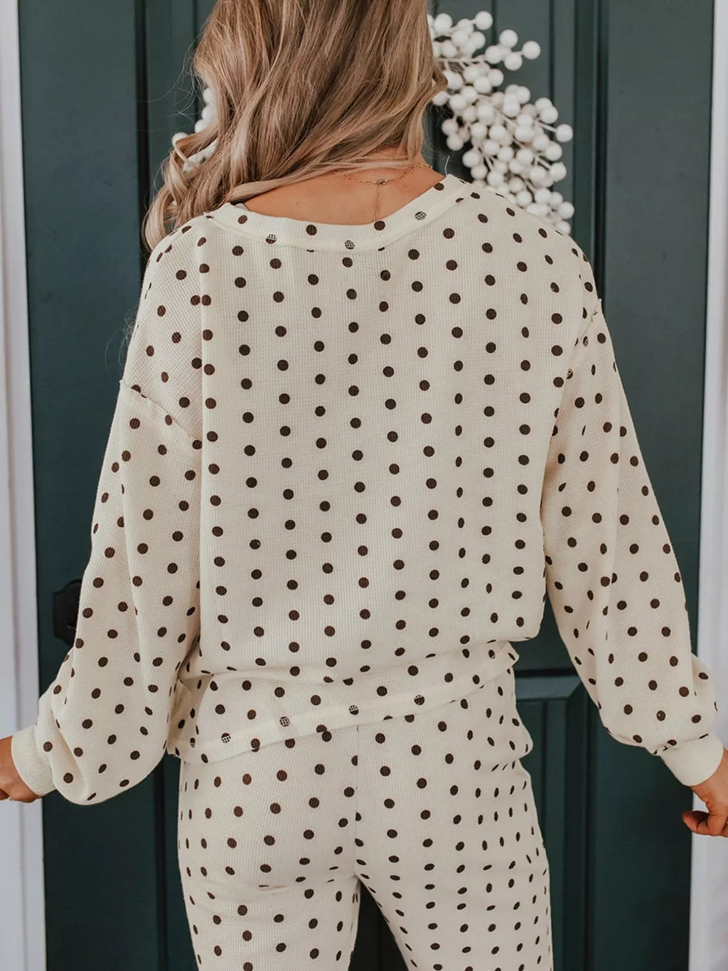 Back view of a woman wearing a Polka Dot Notched Long Sleeve Top and Drawstring Joggers Lounge Set.