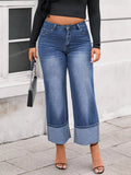 Plus Size High Waist Cuffed Wide Leg Jeans worn with a black top and stylish heels on a sidewalk.
