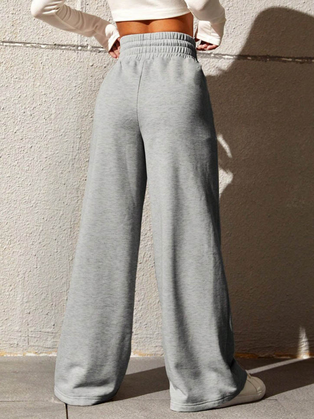 Wide Leg Drawstring Waist Pants in light gray featured from the back view, showcasing their relaxed fit and drawstring waist.