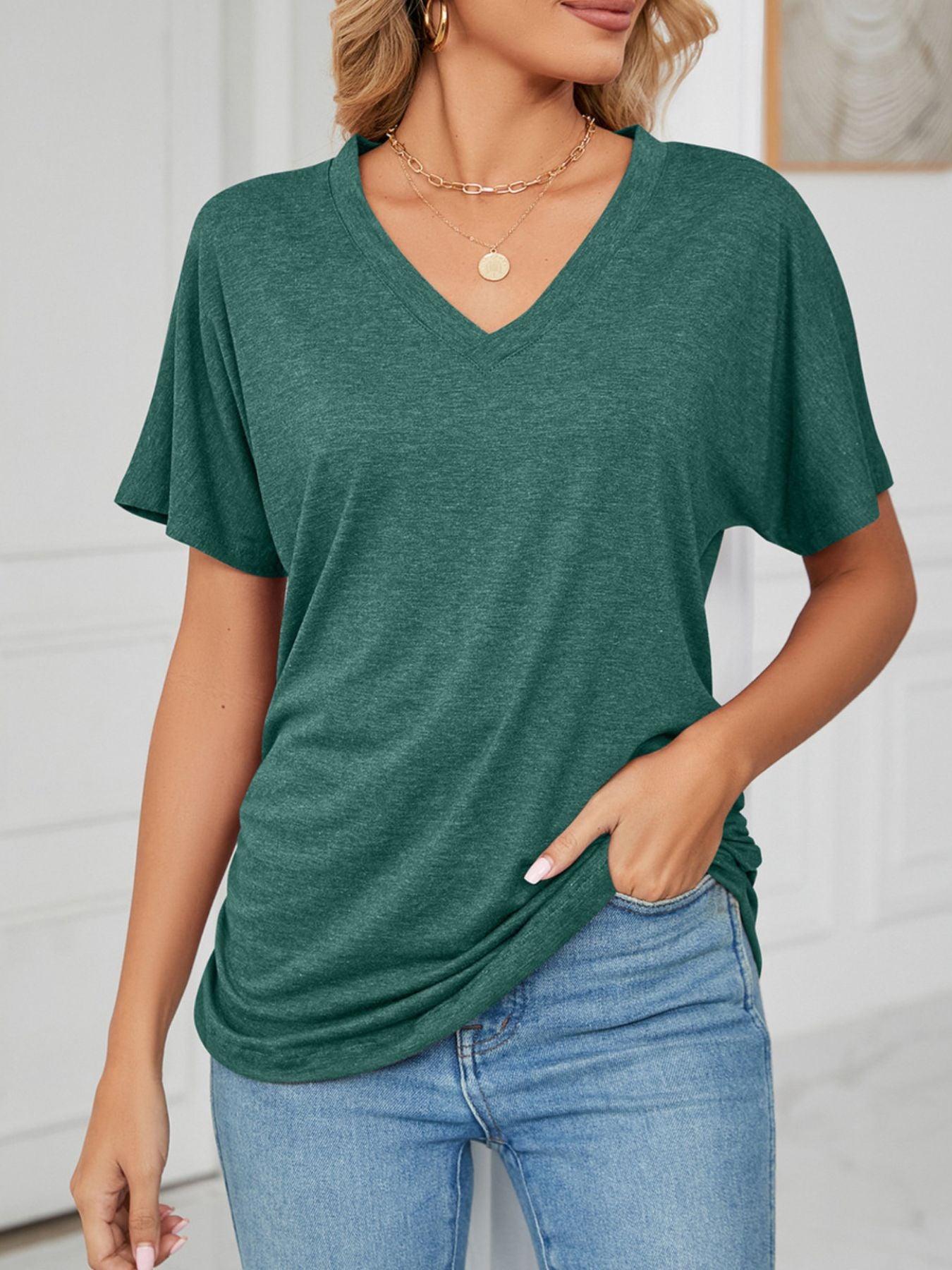 Casual V-Neck Short Sleeve T-Shirt in dark green worn with jeans, offering comfort for relaxed days and casual outings.
