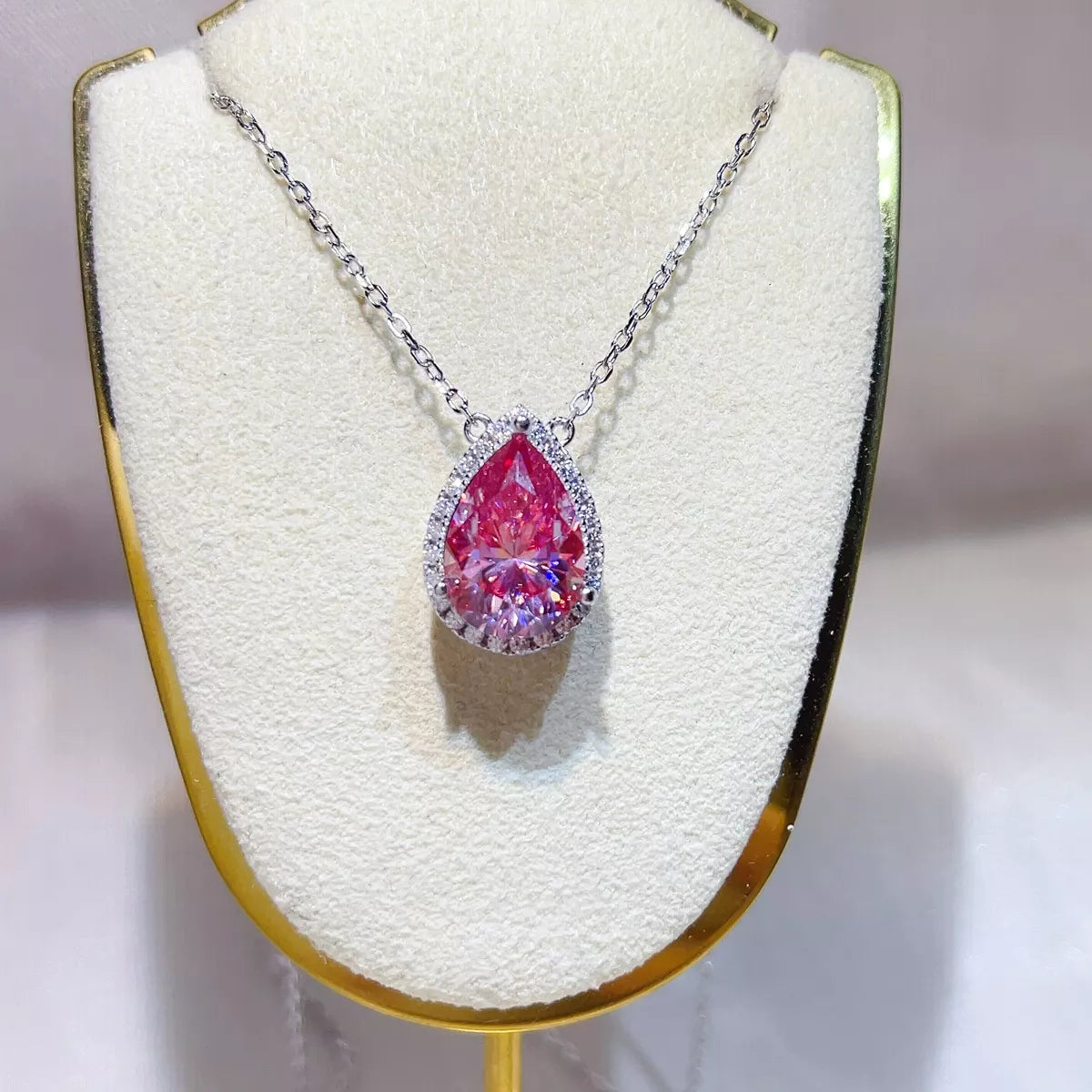 925 sterling silver pendant necklace featuring a stunning pear-shaped pink Moissanite stone.