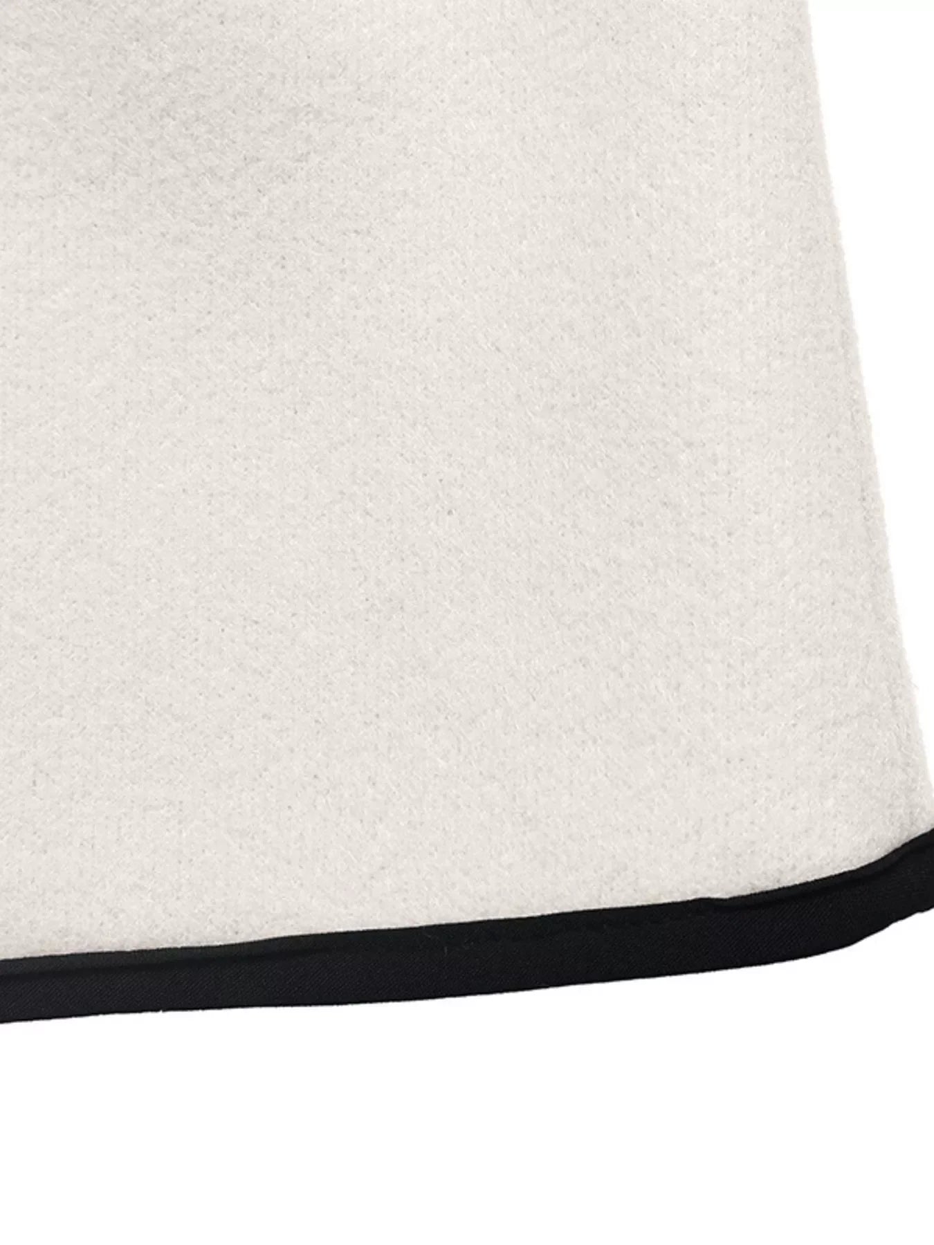 Close-up of the hem detailing of the Contrast Trim Double-Breasted Jacket showing the contrast trim.