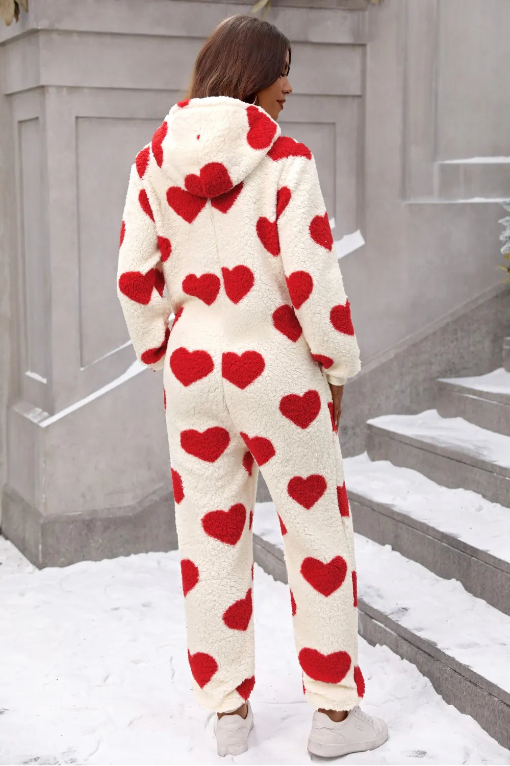 Fuzzy heart lounge jumpsuit with red hearts on cream fabric, cozy and stylish for lounging in winter.