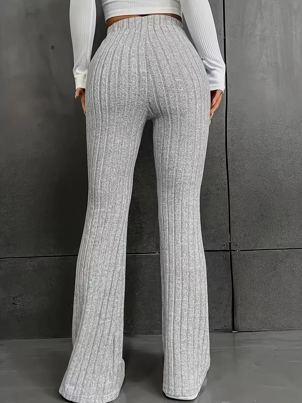 Plus Size Ribbed Knit High Waist Flare Pants showcasing flattering fit and stylish ribbed design from the back.