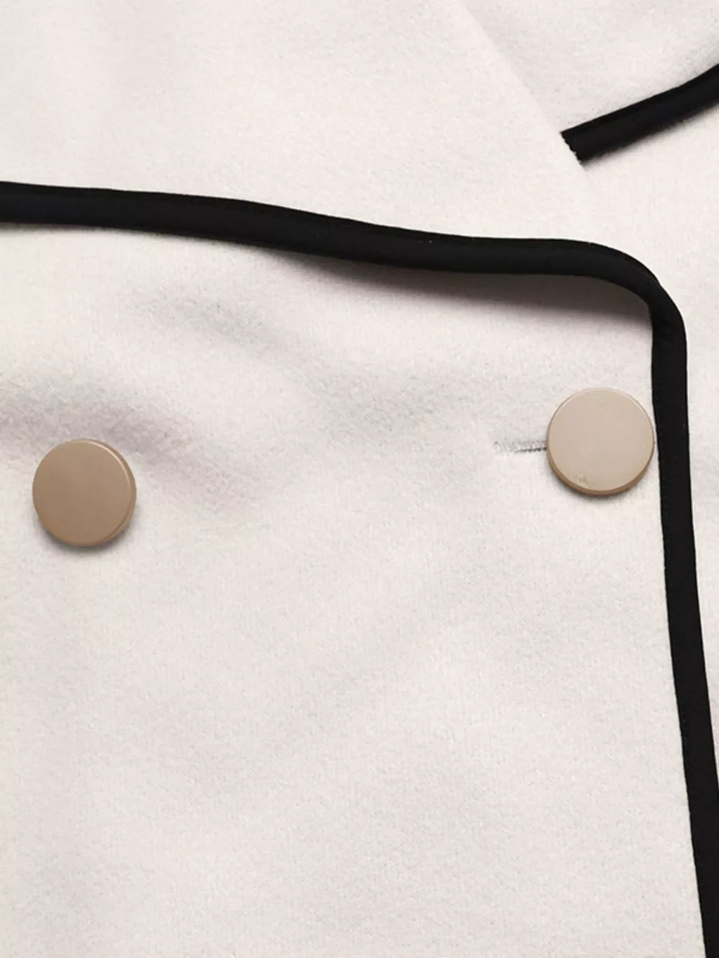 Close-up of the Contrast Trim Double-Breasted Jacket showcasing buttons and bold contrast trim.