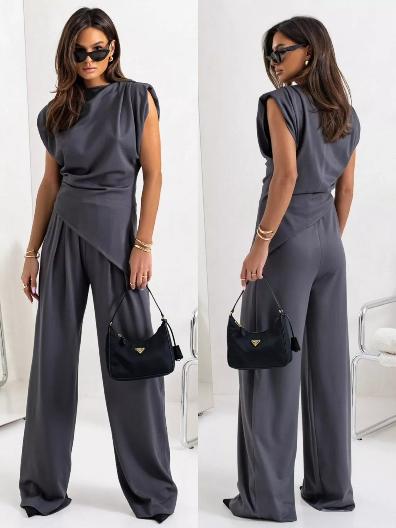 Model wearing a satin cowl neck top and pants set in gray, showcasing elegant style with a chic silhouette.