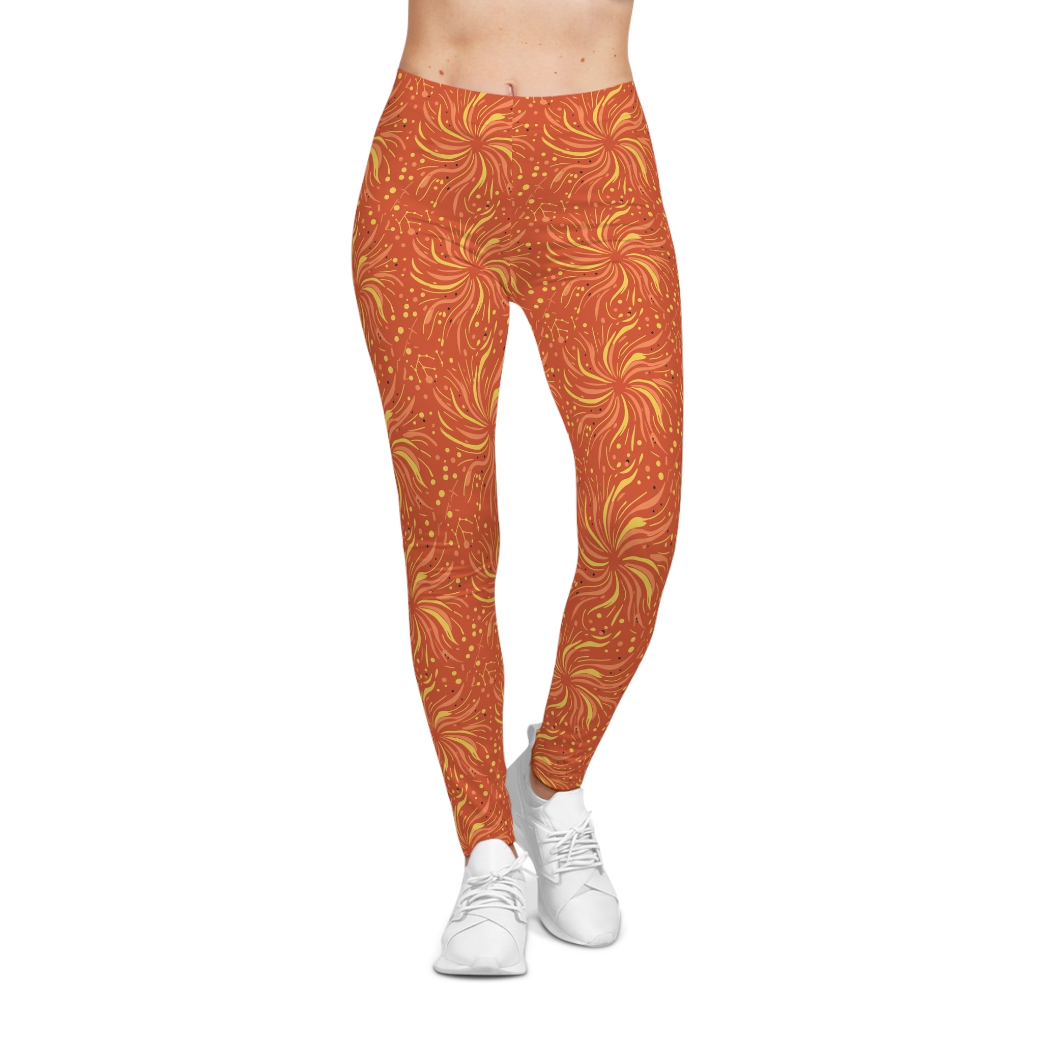 Woman wearing Leo constellation leggings with sunset-orange base and golden sunburst pattern.