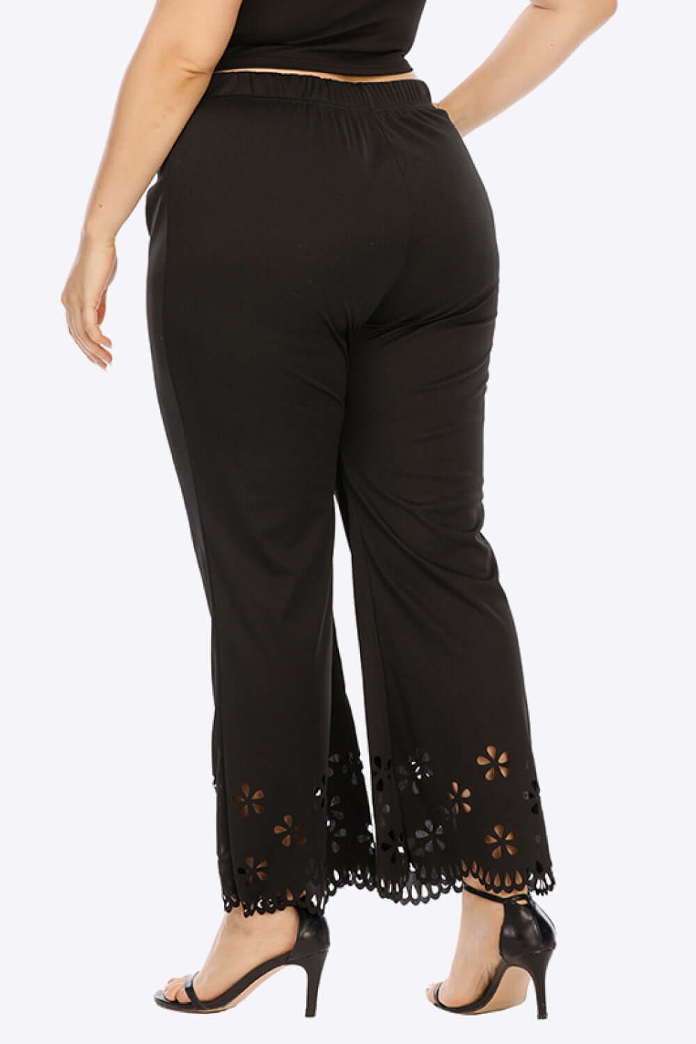 Plus size black pants for women featuring a comfy openwork elastic waist and stylish floral hem.