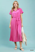 Model wearing a casual midi dress in pink with a collared neck and detachable waist belt.