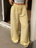 Plus size wide leg pants in yellow with drawstring and high waist, perfect for comfortable styling.