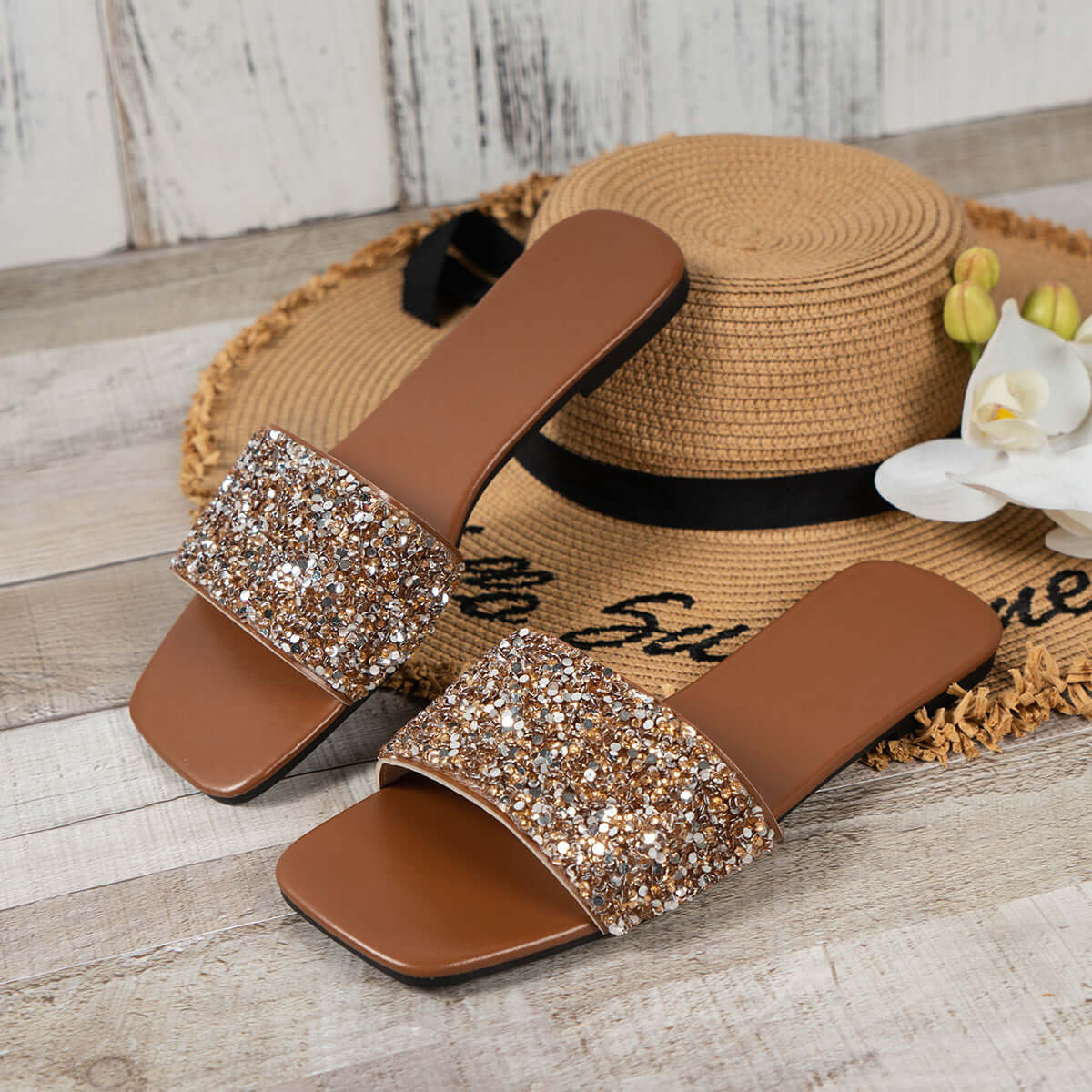 Stylish women's open toe sandals with rhinestone detail on a rustic wooden background, perfect for summer outings.