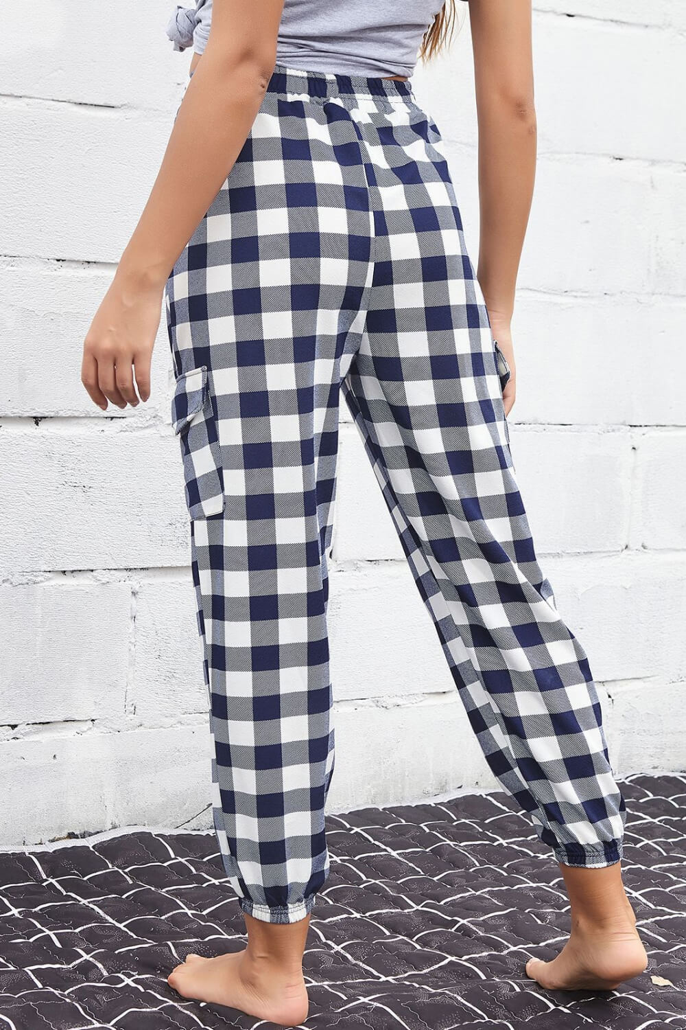 Fashionable cargo pants featuring a trendy plaid pattern and elastic high waist, ideal for casual outings.