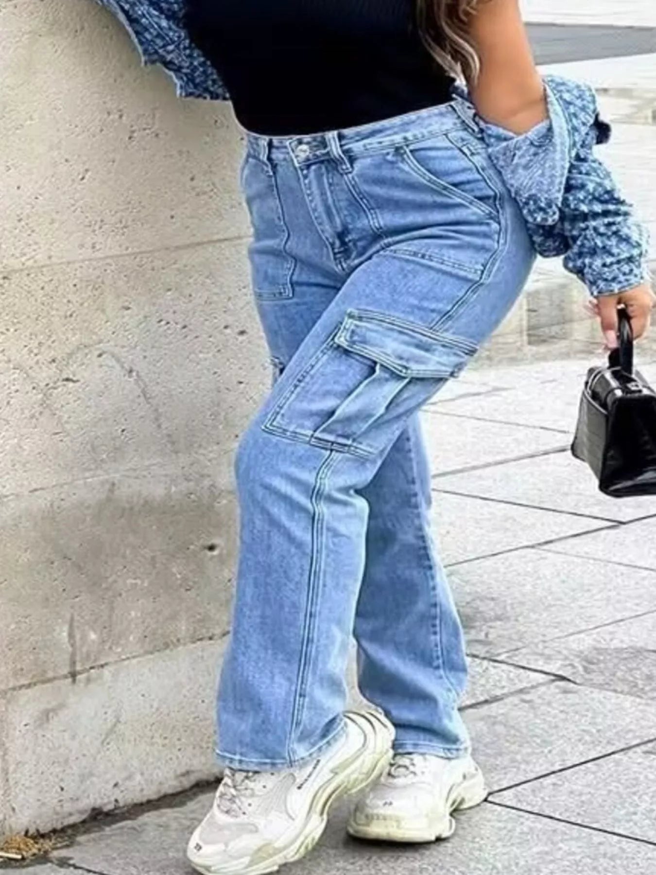 Light Wash Cargo Jeans with Multiple Pockets on a model, showcasing slightly stretchy fabric and inclusive sizing.