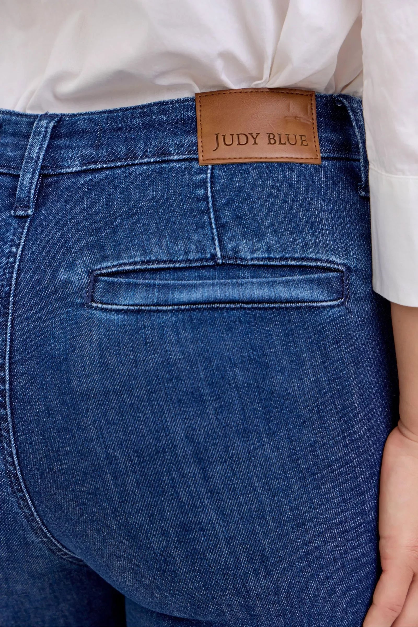 Dark High Waist Flare Jeans with Front Patch Pockets – Trendy Women’s Retro Denim displayed from the back, showcasing the brand tag.