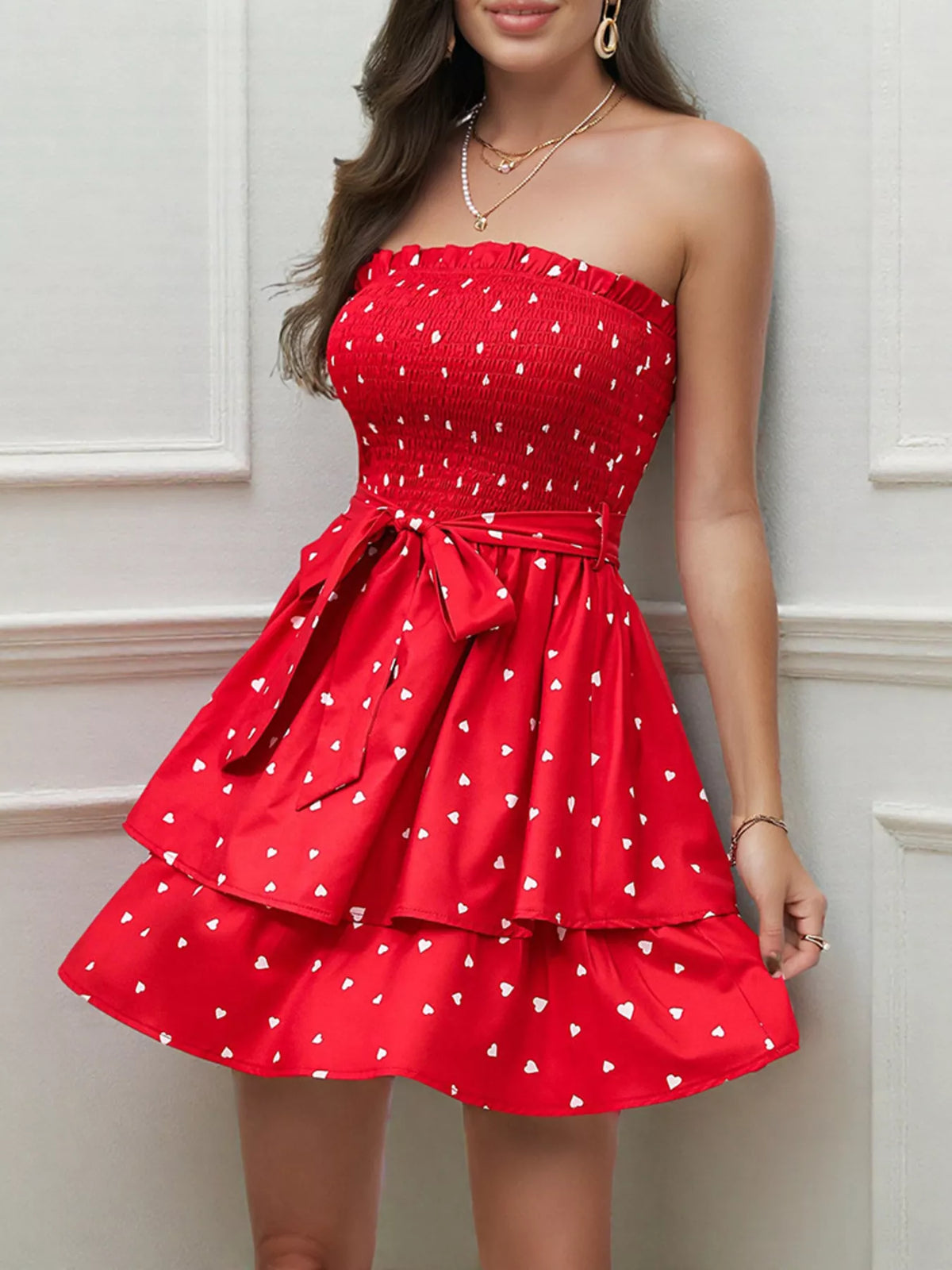 Smocked mini dress in vibrant red with heart patterns and layered skirt, perfect for summer outings.