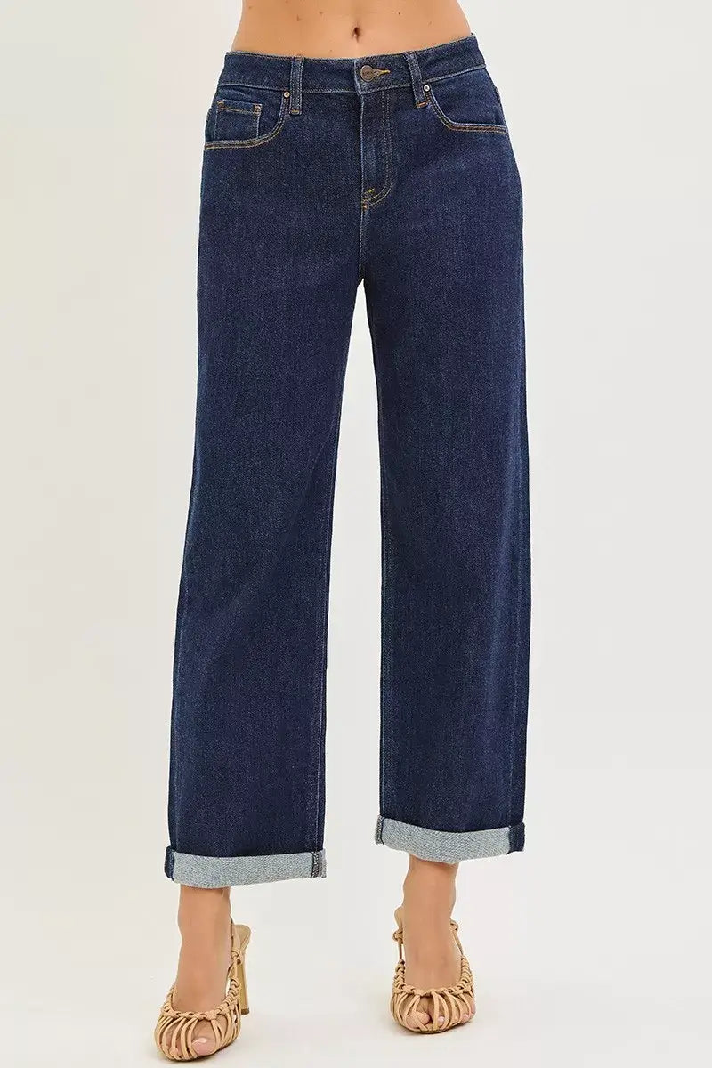 Slouchy cropped boyfriend jeans with cuffed hem, showcasing a relaxed fit and stylish dark denim design.