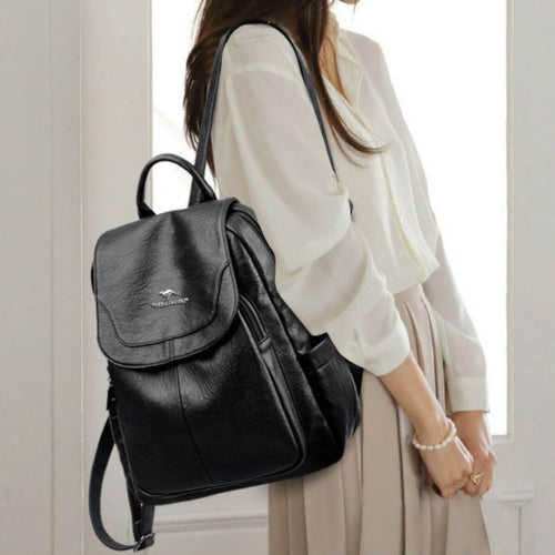 Adjustable Straps Backpack Bag stylishly worn by a woman in a white blouse and beige pants.