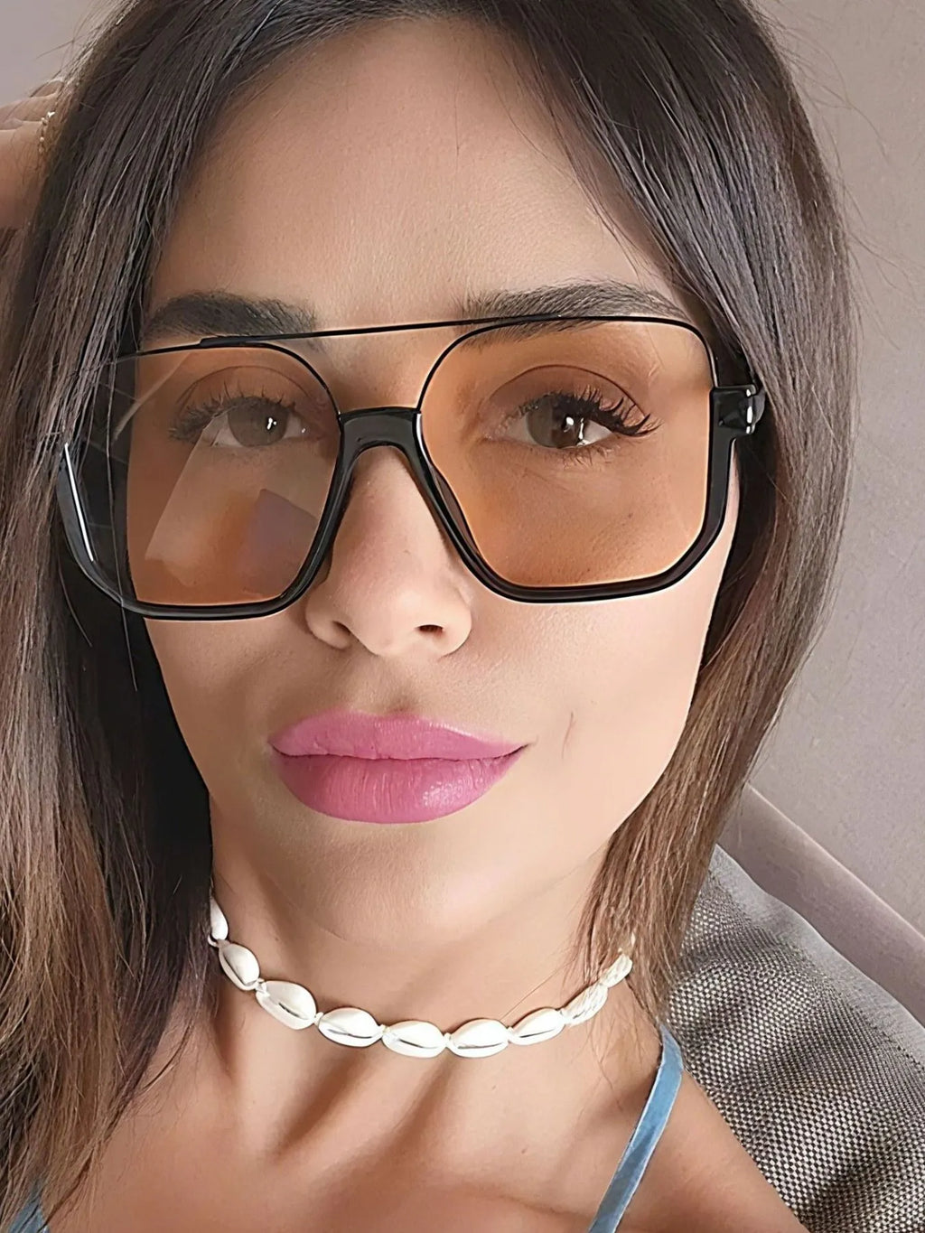 Oversized Square Frame Fashion Sunglasses worn by a woman with stylish makeup and a shell necklace.