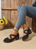 Black Crisscross Block Heel Pumps worn with jeans, showcasing stylish crisscross straps and a sturdy block heel.