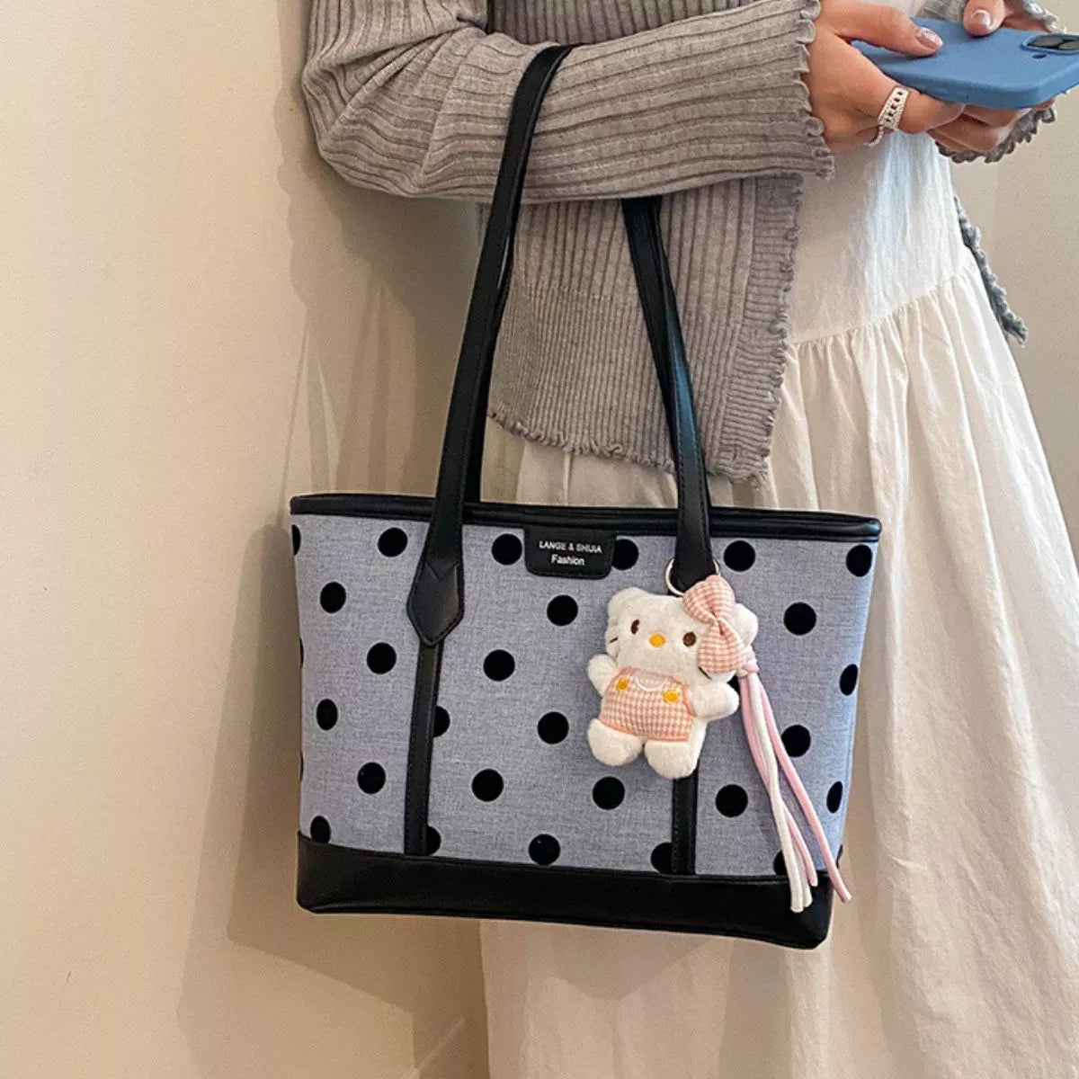 medium polka dot shoulder bag featuring a cute plush keychain and stylish design, perfect for everyday use.