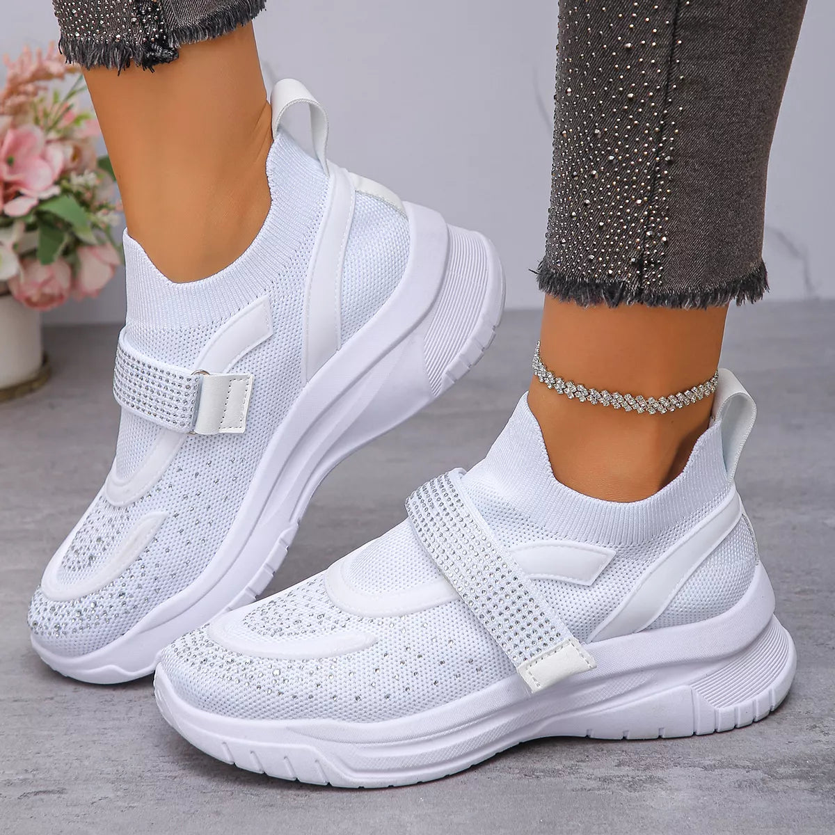 White mesh sneakers with round toe and strap, perfect for stylish and comfortable everyday wear.