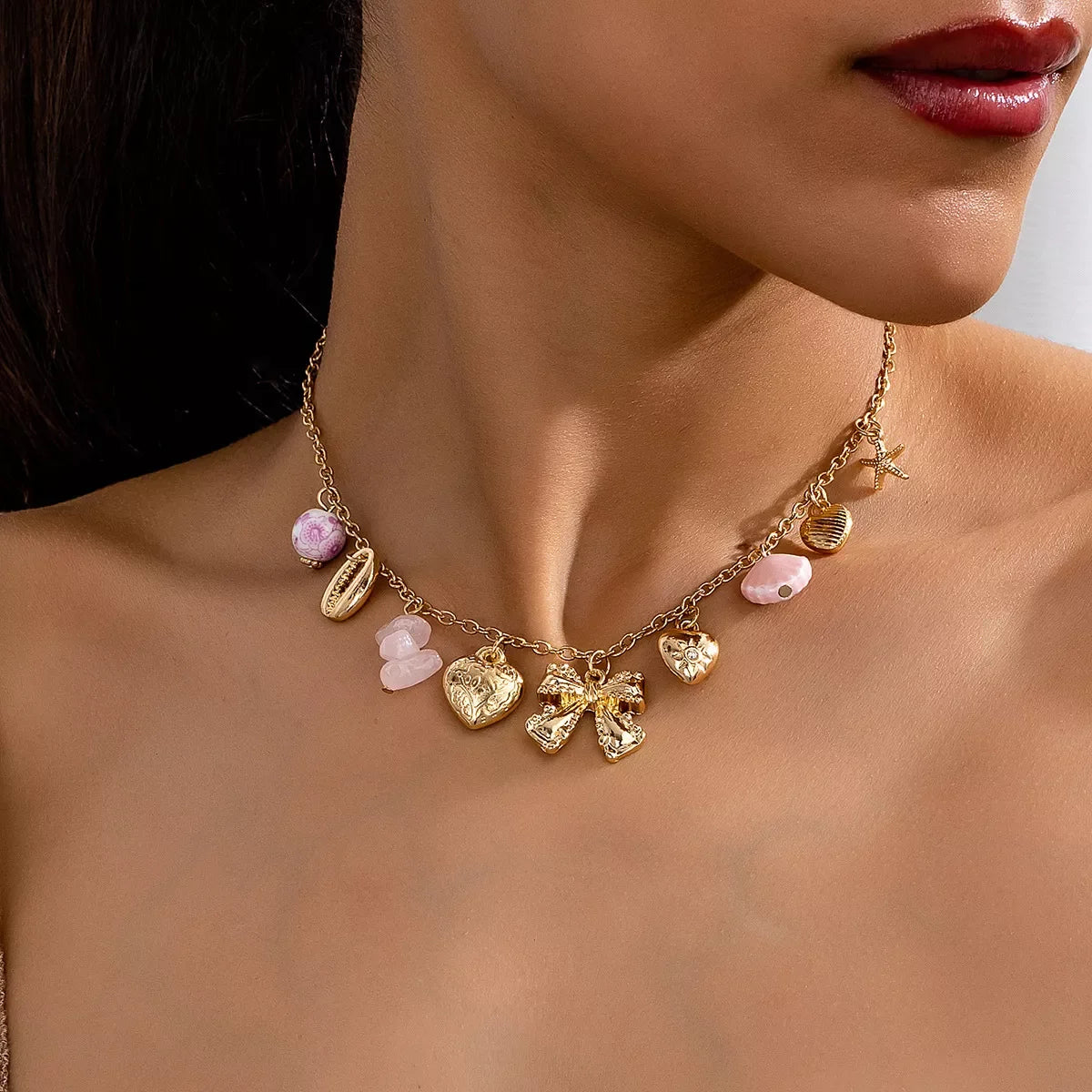 Heart and Butterfly Bow Ocean Multi-Pendant Necklace displayed on model, showcasing layered ocean-inspired pendants.