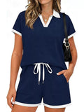 Short sleeve polo set top and shorts featuring drawstring and pockets in navy blue, slightly stretchy material.
