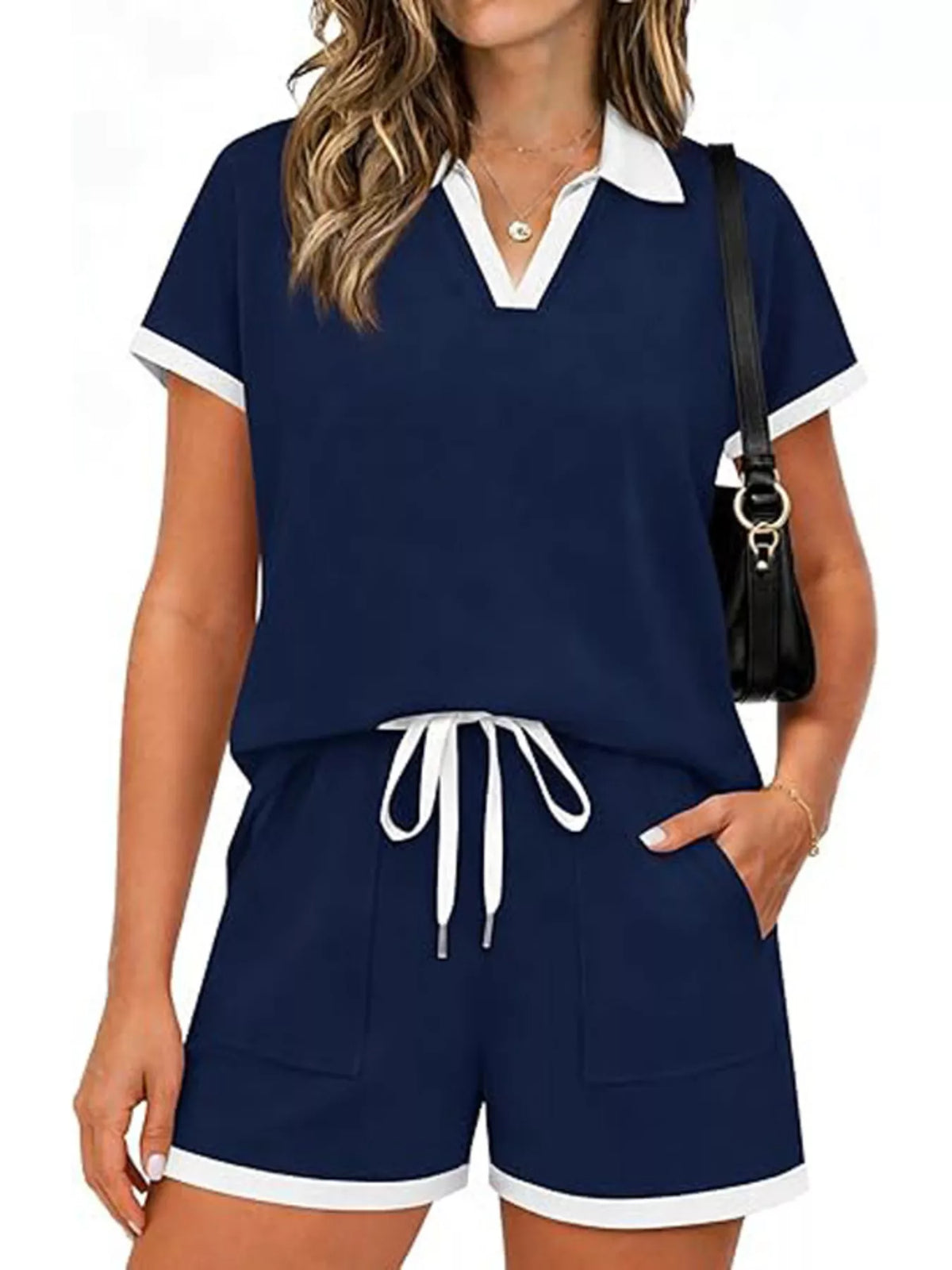 Short sleeve polo set top and shorts featuring drawstring and pockets in navy blue, slightly stretchy material.