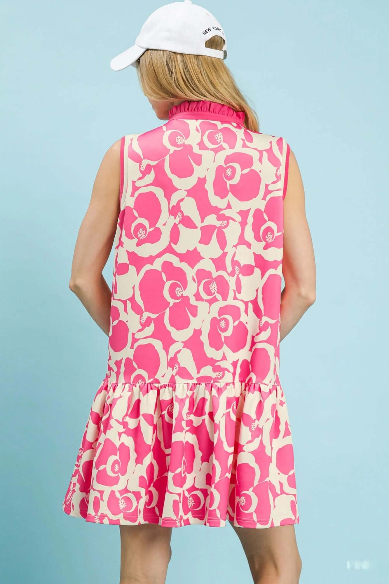 Back view of a floral dress for women featuring a playful ruffle hem and vibrant floral print.